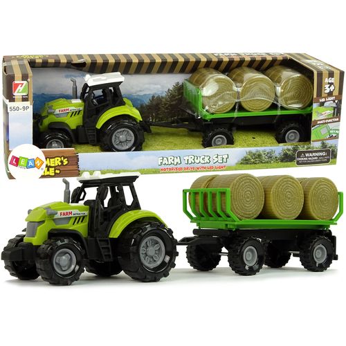 Zeleni traktor s prikolicom i balama sijena slika 1