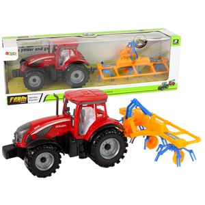 Crveni traktor s grabljama